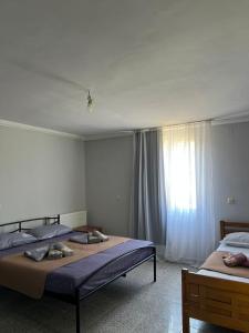 a bedroom with two beds and a window at Liza's house - Block B in Ureki