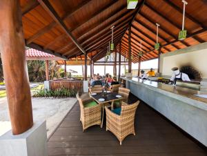 a restaurant with a bar with people sitting at tables at Insight Resort Ahangama in Ahangama
