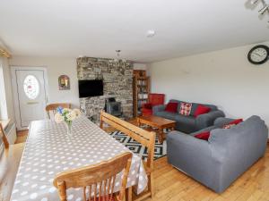 a living room with a table and a couch at Islands Inn in Louisburgh