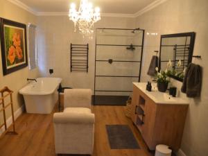 a bathroom with a tub and a sink and a bath tub at Fiore Guest Accommodation in Greyton