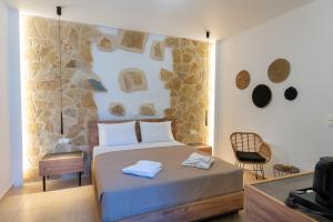 a bedroom with a bed with two towels on it at GardenBlue By Gereoudis in Kolymvari +99 photos