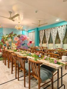 a dining room with long tables and chairs at Sarang Palace - A Luxury Boutique Hotel in Jaipur