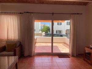 a living room with a door open to a patio at Sa TORRE 3 by SOM Menorca in Fornells