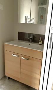 a bathroom vanity with a sink and a mirror at Relais Fléchois in La Flèche