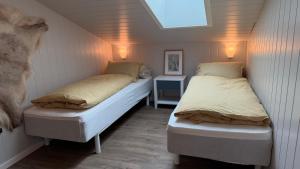 a couple of beds in a small room at Bergnes Lodge in Senja