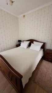 a bedroom with a large bed with white sheets at Motel in Sarny