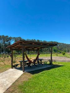 a picnic shelter with a bench and a hammock at Liza's house - Block B in Ureki