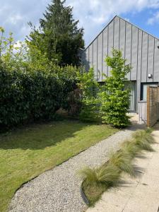 a house with a garden in front of a building at My Spa in Reims