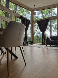 a living room with a chair and a couch at DEIVID house for rent in Skulte