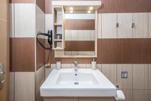 a bathroom with a white sink and a mirror at Mathios Apartments Falassarna in Falasarna +64 photos