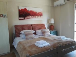 a bedroom with a large bed with towels on it at Bright 2BR Apt Kitchenette Pool 3 in Gouvia