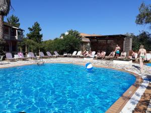 a swimming pool with a ball in the water at Bright 2BR Apt Kitchenette Pool 3 in Gouvia +34 photos