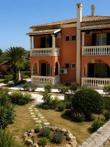 a house with a garden in front of it at Bright 2BR Apt Kitchenette Pool 3 in Gouvia