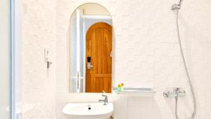 a bathroom with a sink and a mirror at Baliem Boutique Hotel Ungasan in Jimbaran +13 photos