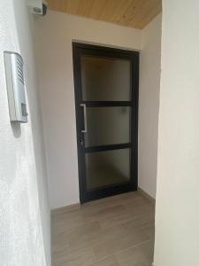 a black door in a hallway with a tile floor at Leonardo in Veglie