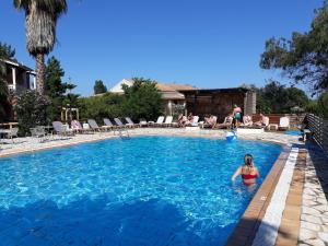 a girl in the water in a swimming pool at Studio Gouvia Kitchenette Pool 8 in Gouvia