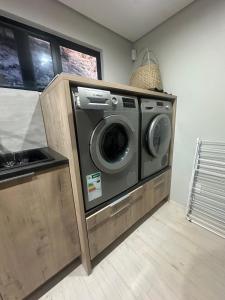 a washer and dryer sitting in a room at Sunset Villa Herolds Bay in Herolds Bay
