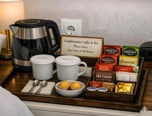 a tray with food and coffee on a table with a coffee maker at Studio Gouvia Kitchenette Pool 5 in Gouvia