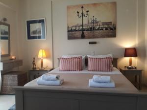 a bedroom with a large bed with two towels on it at Studio Gouvia Kitchenette Pool 5 in Gouvia
