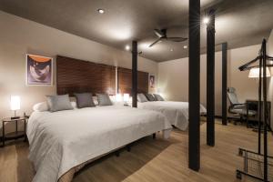 a bedroom with two beds and a ceiling fan at SNUGGLE2222 Odawara Nakacho in Odawara
