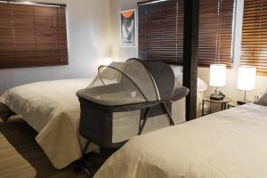a room with two beds and a bag on a chair at SNUGGLE2222 Odawara Nakacho in Odawara +32 photos