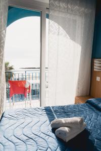 a bedroom with a bed and a large window at Hotel Ambassador in Grottammare +99 photos