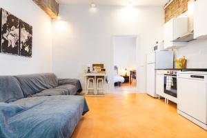 a living room with a couch and a kitchen at Almenara in Almenara