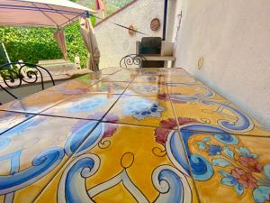 a colorful tile floor in a room with an umbrella at B&B Villa Rosa Angrisano in Maratea