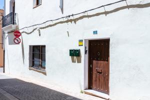 a door on the side of a white building at Almenara in Almenara