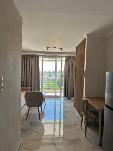 a room with a table and a chair and a desk at Sun Studios Pieria in Paralía Skotínis