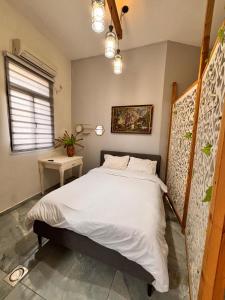 a bedroom with a large white bed and a window at Diamond Studio Apartment - Haifa in Haifa