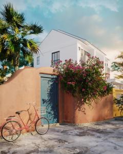 a pink bike parked next to a building with flowers at The Mansion Hoi An by Minova in Hoi An