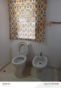 a bathroom with a toilet and a shower curtain at Tranquil villa in Watamu