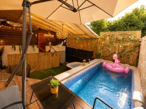 a swimming pool with a pink inflatable rubber duck in it at Spa Mari TLV in Tel Aviv