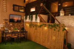 a dining room with a table and a tv on a wall at Spa Mari TLV in Tel Aviv