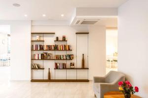 a living room with a book shelf filled with books at Summer Dream in Rethymno