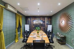 a conference room with a long table and chairs at Grand Daddy Boutique Hotel in Cape Town