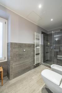 a bathroom with a shower and a toilet and a sink at PRIMA FILA Premium Guest House in Sanremo +18 photos