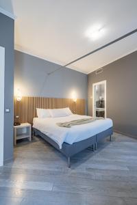 a bedroom with a large bed in a room at PRIMA FILA Premium Guest House in Sanremo