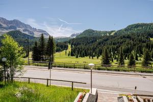 an empty road with mountains in the background at Chalet Campiglio Mountain View - Guardabassi Collection in Madonna di Campiglio