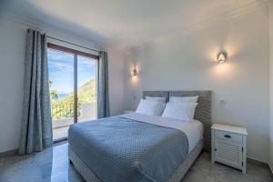 a bedroom with a bed and a large window at Villa Excelsior in Porto Ota +72 photos
