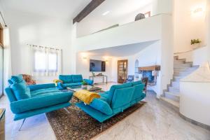 a living room with blue couches and a fireplace at Villa Excelsior in Porto Ota