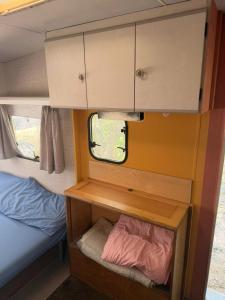 a small room with a cabinet and a bed in a trailer at Vita Da Pacos in Novilara