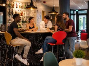 a group of people sitting at a bar at Ibis Budget Orly Chevilly Tram 7 in Chevilly-Larue
