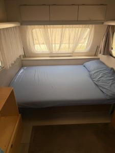 a bed in a small room with a window at Vita Da Pacos in Novilara