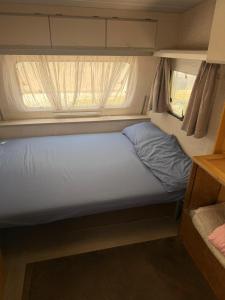 a bed in an rv with a window at Vita Da Pacos in Novilara +8 photos