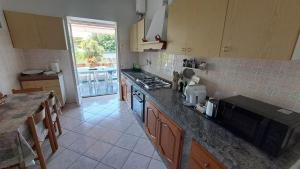 a kitchen with a counter and a stove top oven at CAPERCIA home in Forio d'Ischia