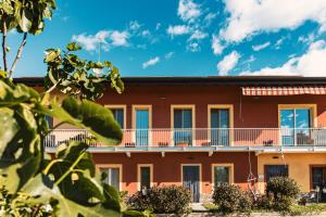 an apartment building with balconies on the side at Agriturismo Why Farm in Marano Ticino