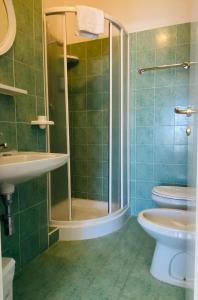a bathroom with a shower and a toilet and a sink at Hotel Europa in Gabicce Mare +30 photos