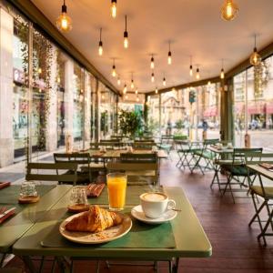 a table with a plate of croissants and a cup of coffee at AH - Duomo Signature in Milan